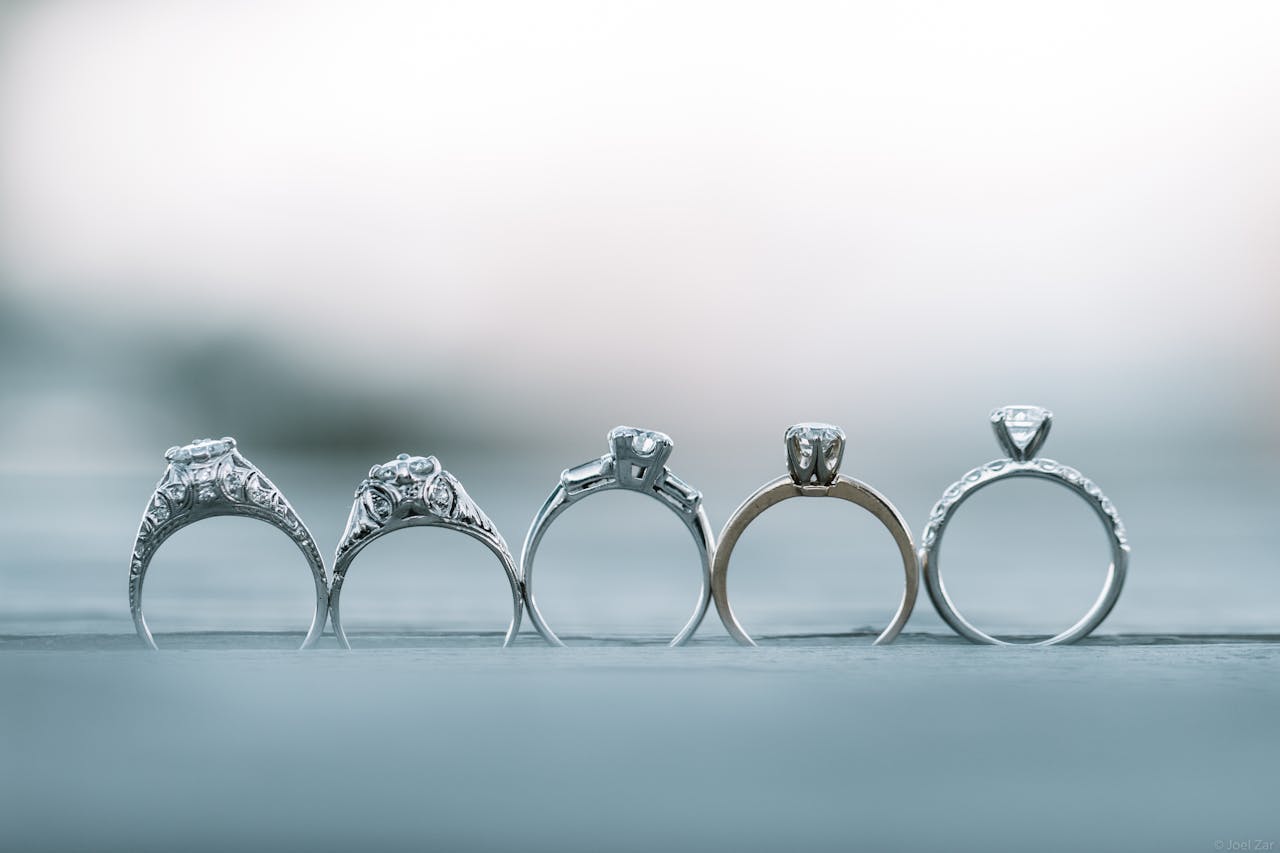 Close-up of intricately designed diamond engagement rings with shallow depth of field.